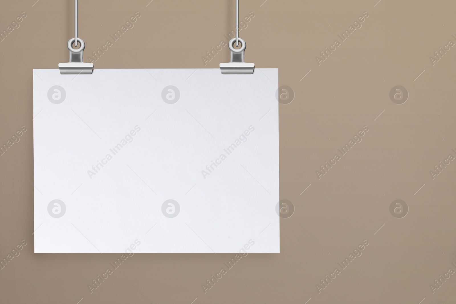 Image of Blank poster hanging near beige wall. Space for design