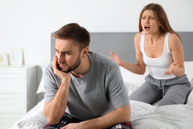 Young couple quarreling in bedroom. Relationship problems