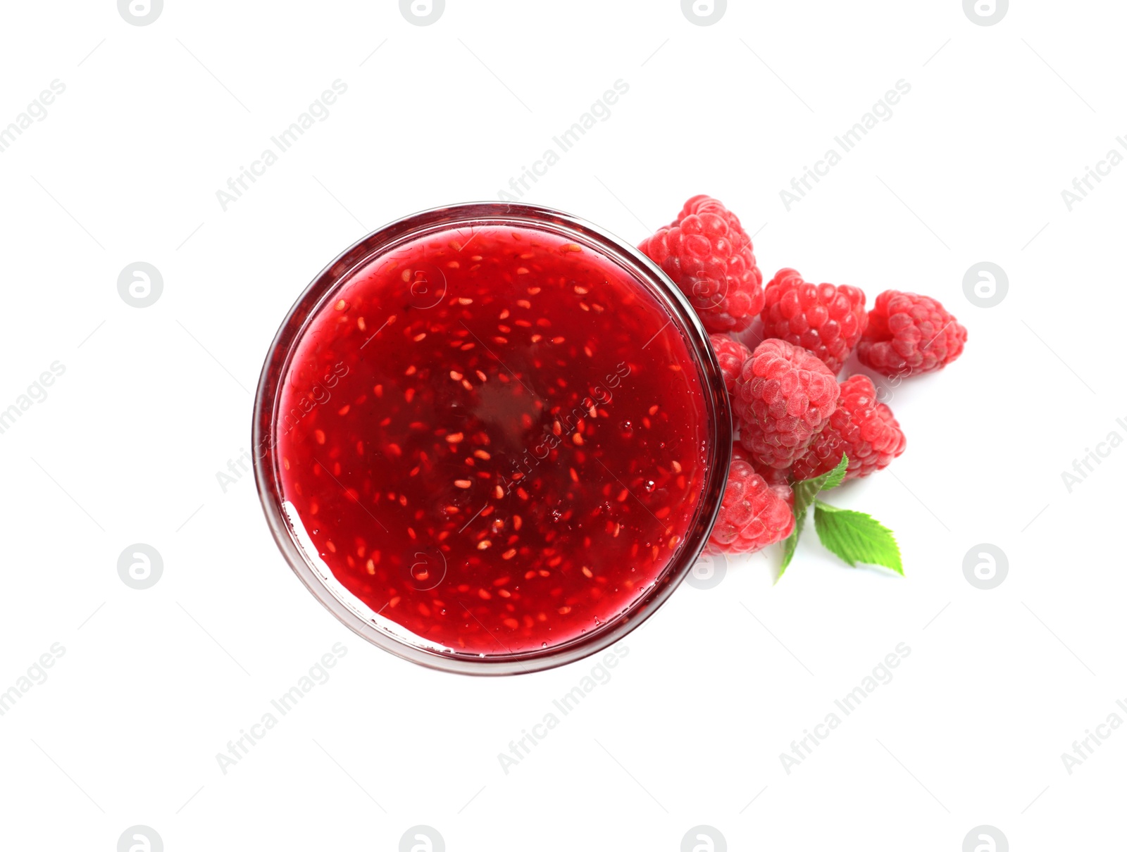 Photo of Bowl of sweet jam with ripe raspberries and green leaves on white background, top view