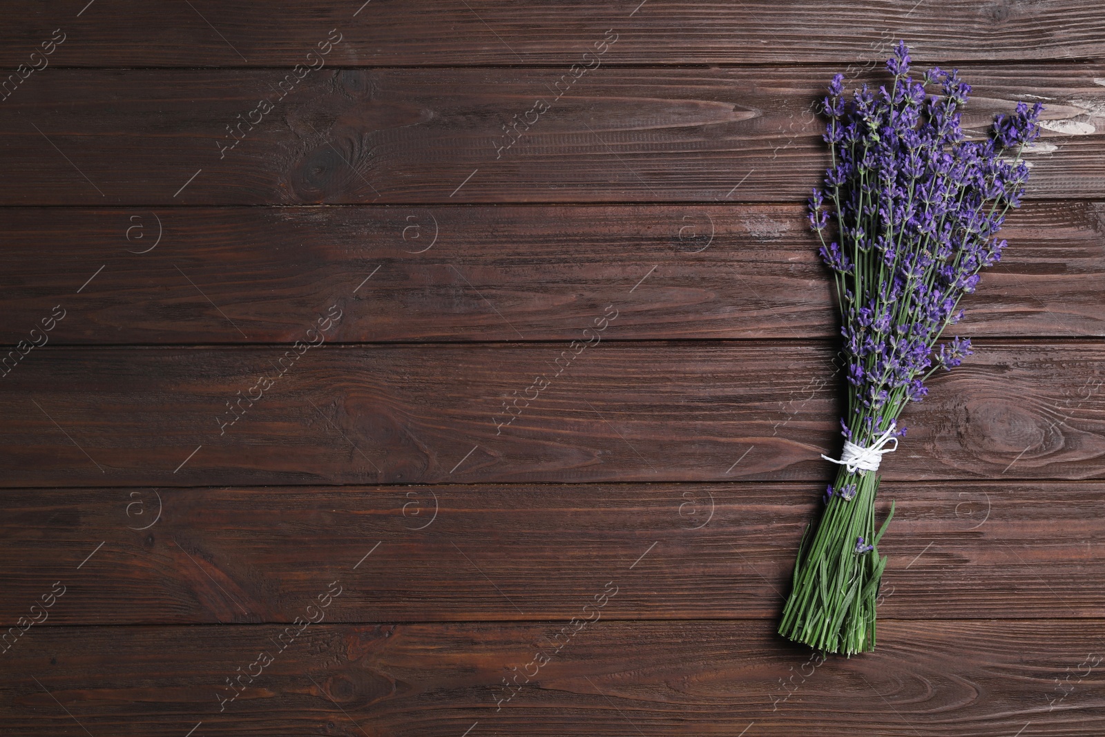 Photo of Beautiful lavender bouquet on wooden background, top view. Space for text