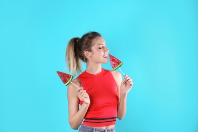 Photo of Young pretty woman with candies on colorful background