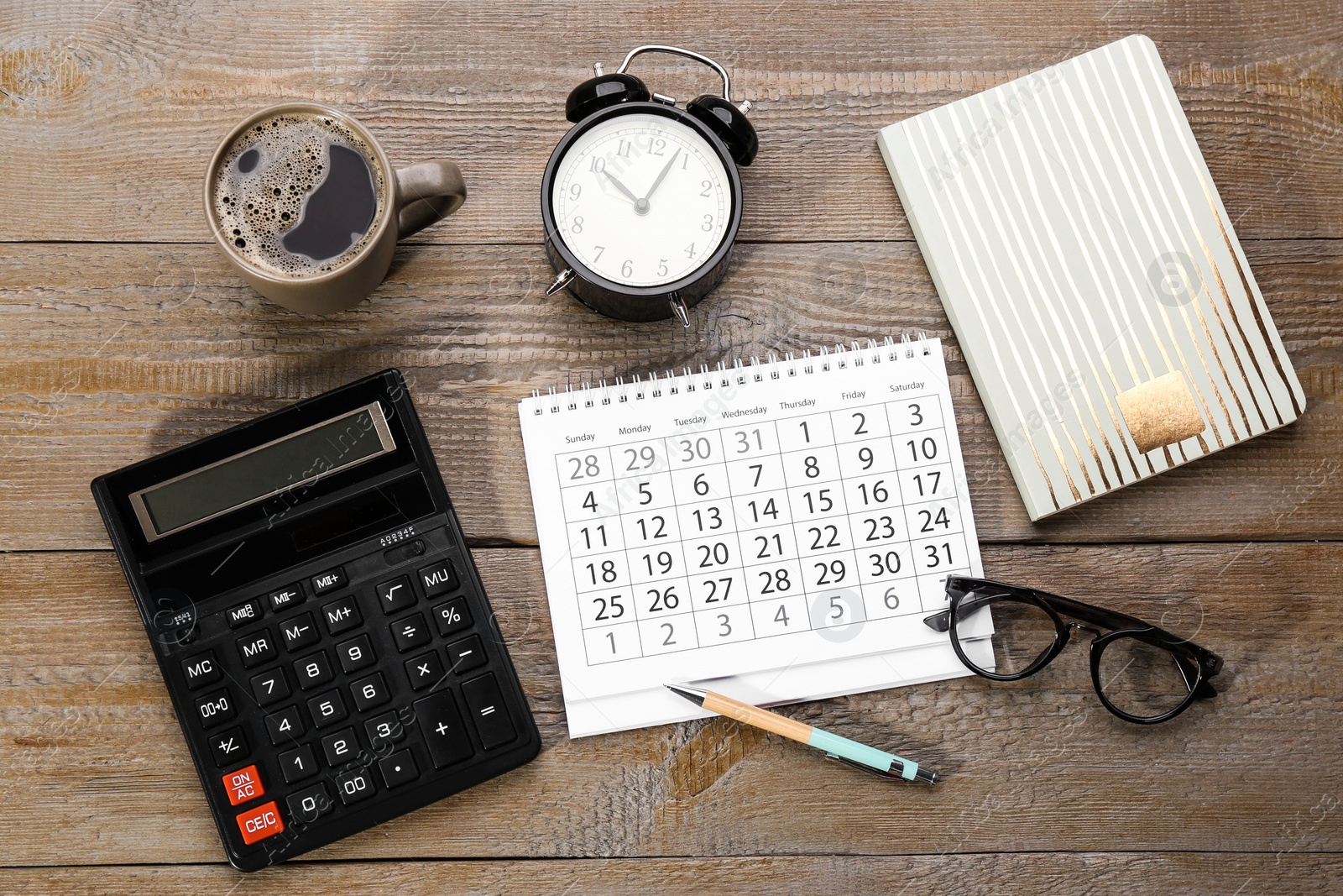 Photo of Flat lay composition with calendar and cup of coffee on wooden table