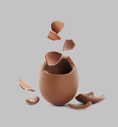 Image of Exploded milk chocolate egg on grey background