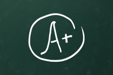 School grade. Letter A with plus symbol on green chalkboard