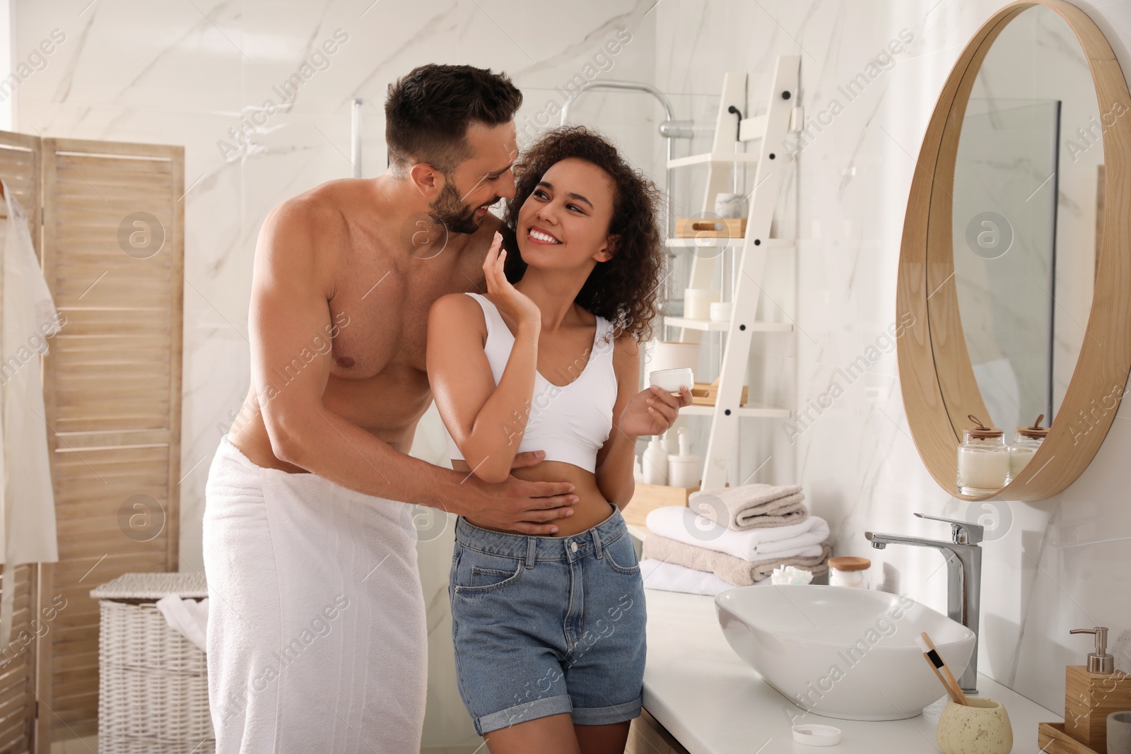 Photo of Lovely couple enjoying each other in bathroom at home