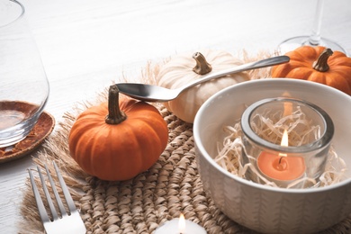 Photo of Autumn table setting with pumpkins on white background