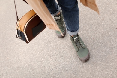 Photo of Young woman in comfortable casual shoes walking on street