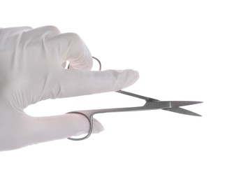 Photo of Doctor holding surgical scissors on white background, closeup. Medical instrument