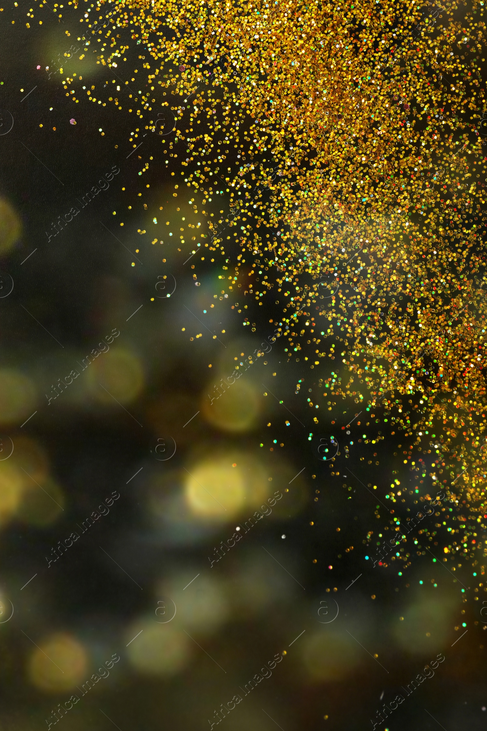 Photo of Shiny golden glitter on blurred background with bokeh effect. Space for text