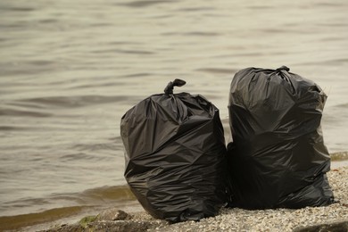 Photo of Trash bags full of garbage on beach
