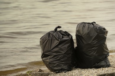 Trash bags full of garbage on beach