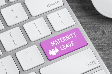 Modern computer keyboard with text MATERNITY LEAVE on table, closeup