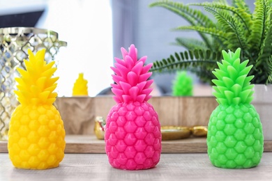 Pineapple shaped candles on table