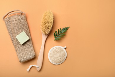 Photo of Flat lay composition with eco friendly products on pale orange background, space for text