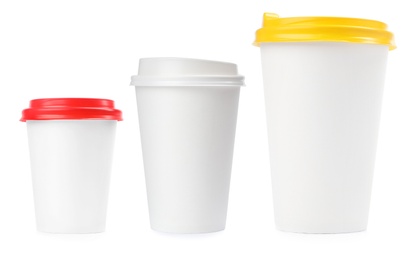 Image of Set with different paper coffee cups on white background 