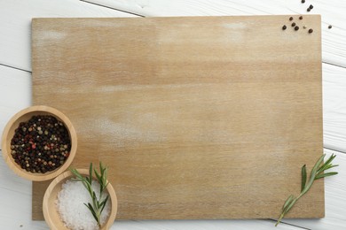 Photo of Cutting board and different spices on white wooden table, flat lay