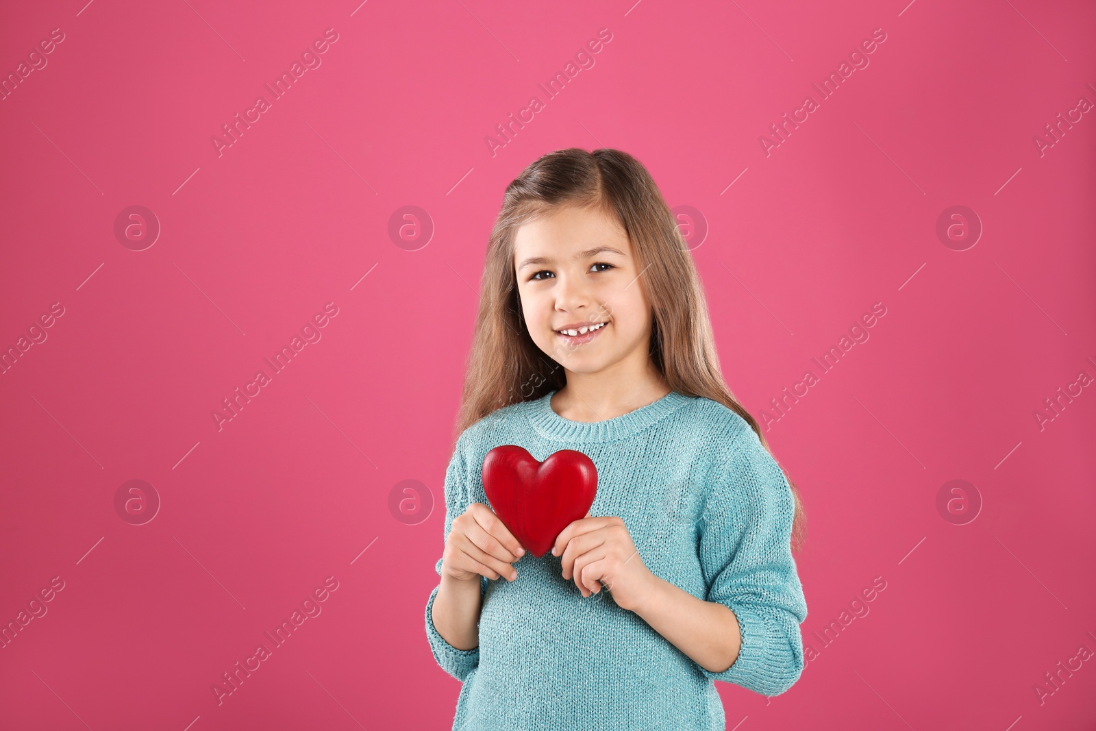 Photo of Portrait of girl with decorative heart on color background