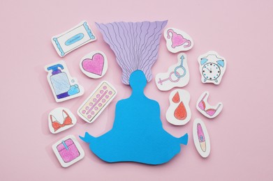 Photo of Woman paper figure with personal hygiene products and gender sign on pink background, flat lay