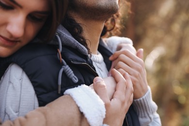Photo of Young couple hugging outdoors, closeup. Dating agency