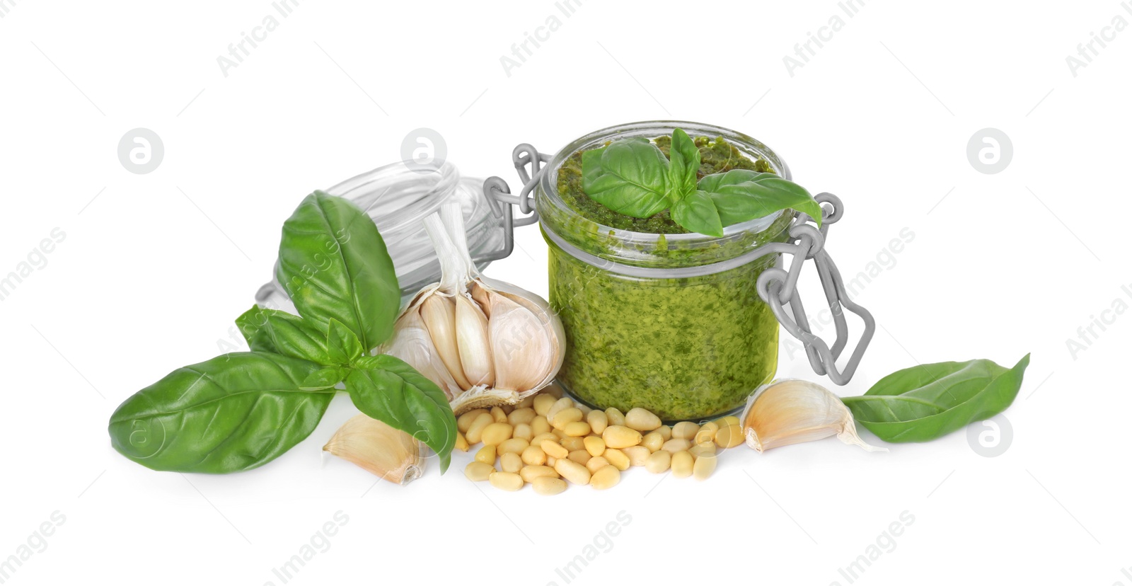 Photo of Delicious pesto sauce in jar and ingredients isolated on white