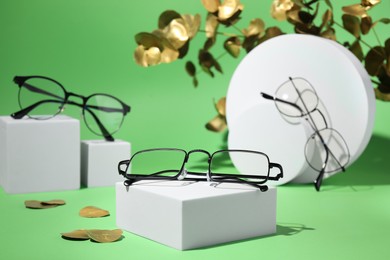 Photo of Stylish presentation of different glasses on green background