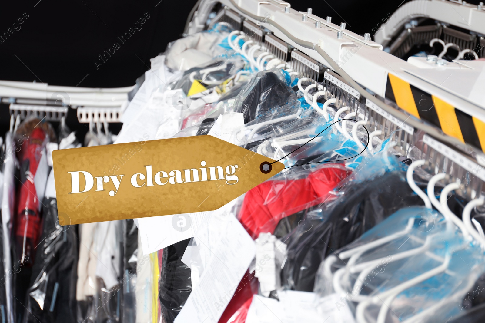 Image of Hangers with clothes on garment conveyor at dry-cleaner's