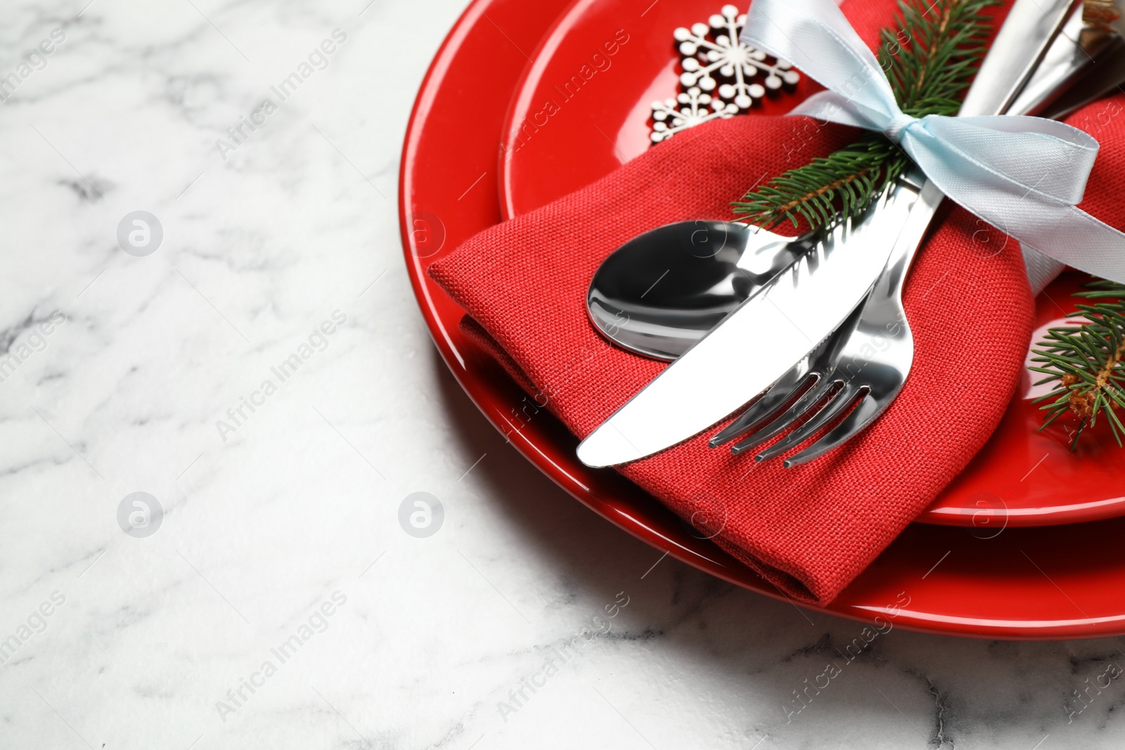 Photo of Festive table setting with beautiful dishware and Christmas decor on white marble background. Space for text