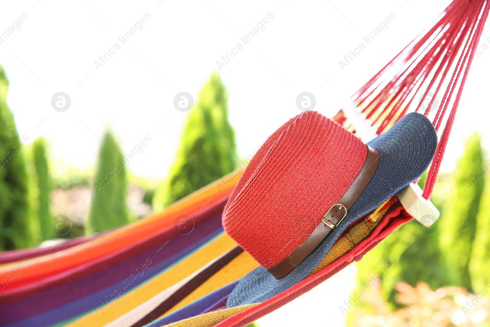 Photo of Colorful hammock with hat outdoors on sunny day