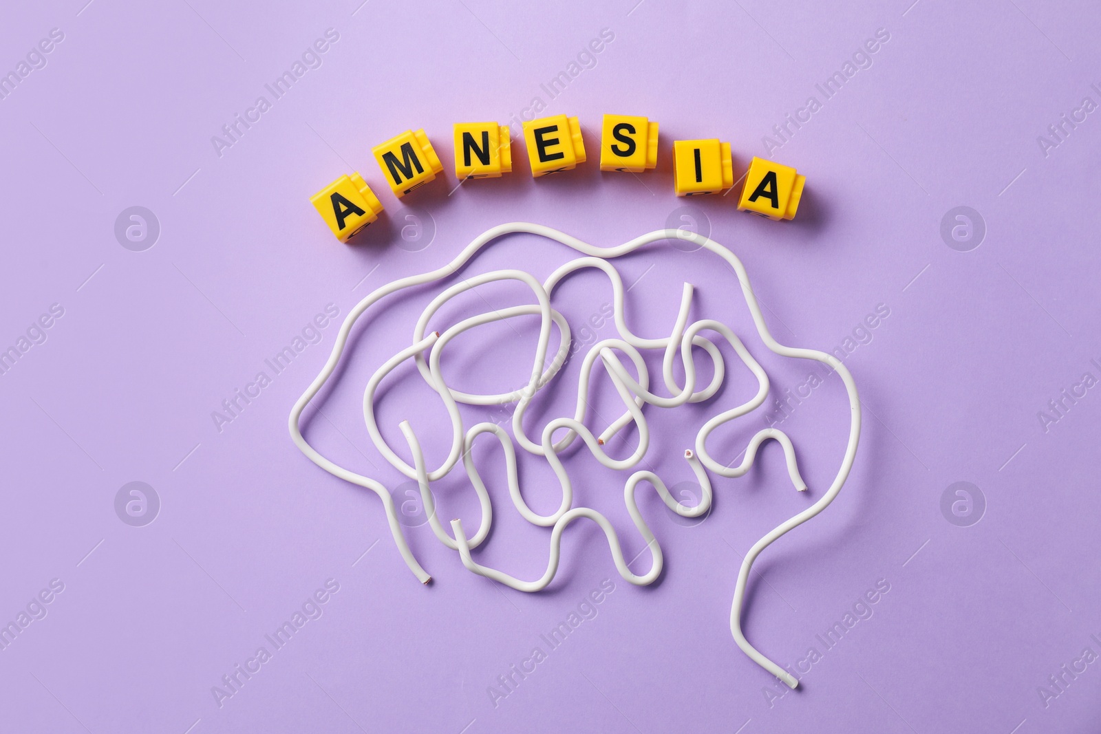 Photo of Word Amnesia and brain made of wires on violet background, flat lay