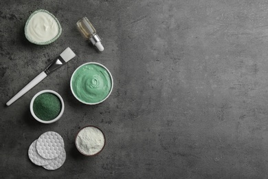Photo of Flat lay composition with spirulina facial mask and ingredients on grey table. Space for text