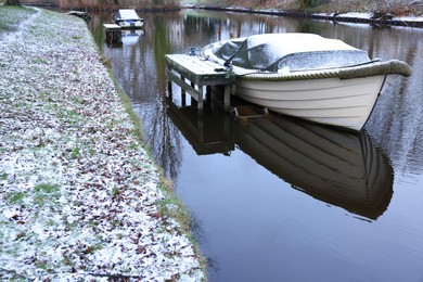 Photo of Water canal with moored boats on winter day