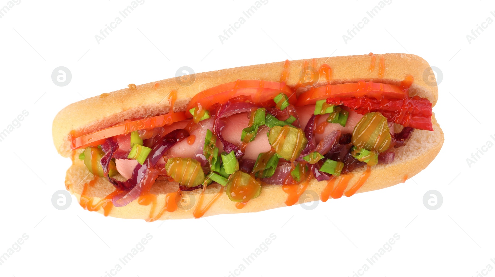 Photo of One tasty hot dog with green onion, tomato, pickles and sauce isolated on white, top view