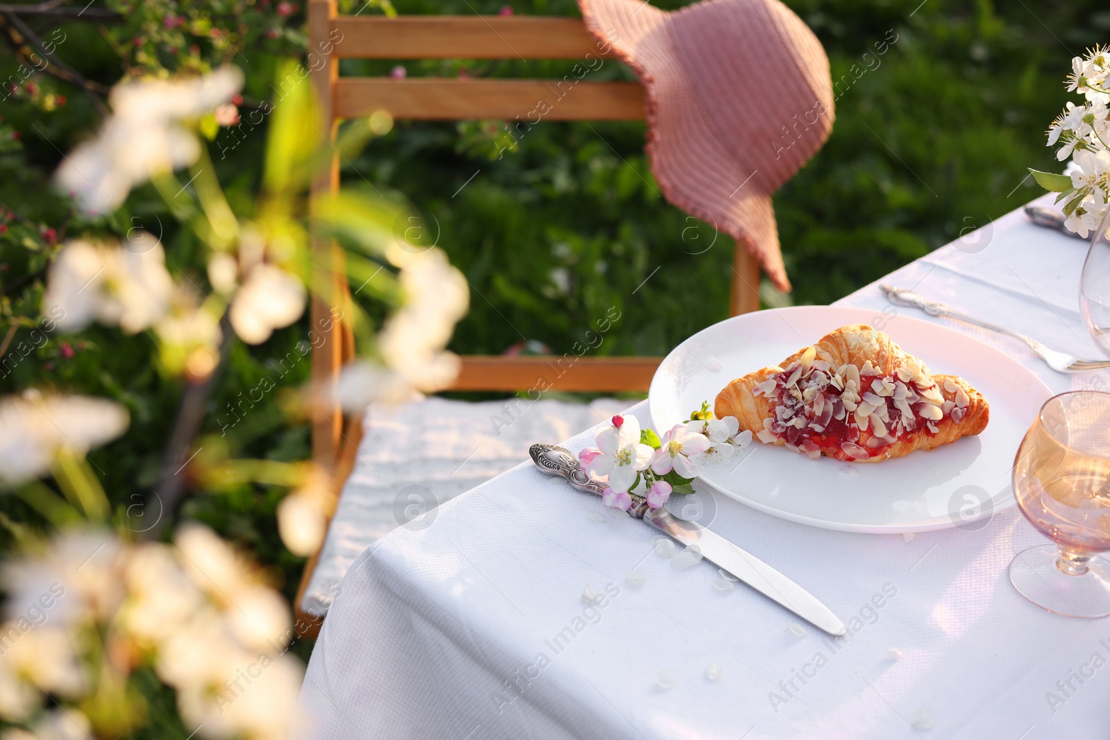 Photo of Stylish table setting with beautiful spring flowers in garden