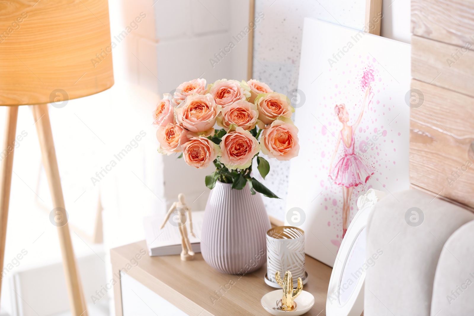 Photo of Vase with beautiful flowers on chest of drawers in modern room interior