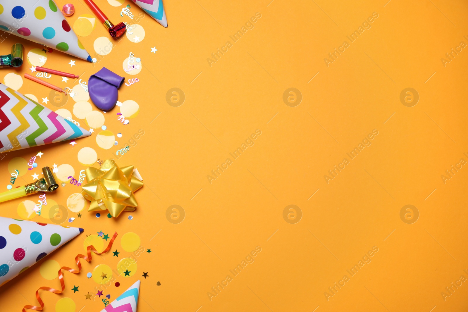 Photo of Flat lay composition with party items on orange background, space for text