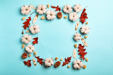 Photo of Flat lay composition with cotton flowers on blue background, space for text