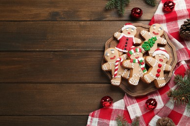 Photo of Delicious Christmas cookies and festive decor on wooden table, flat lay. Space for text