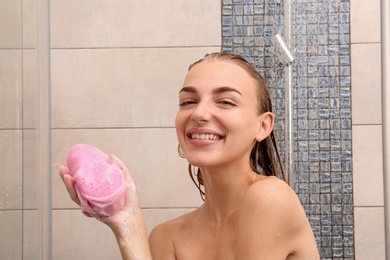 Photo of Beautiful young woman taking shower at home