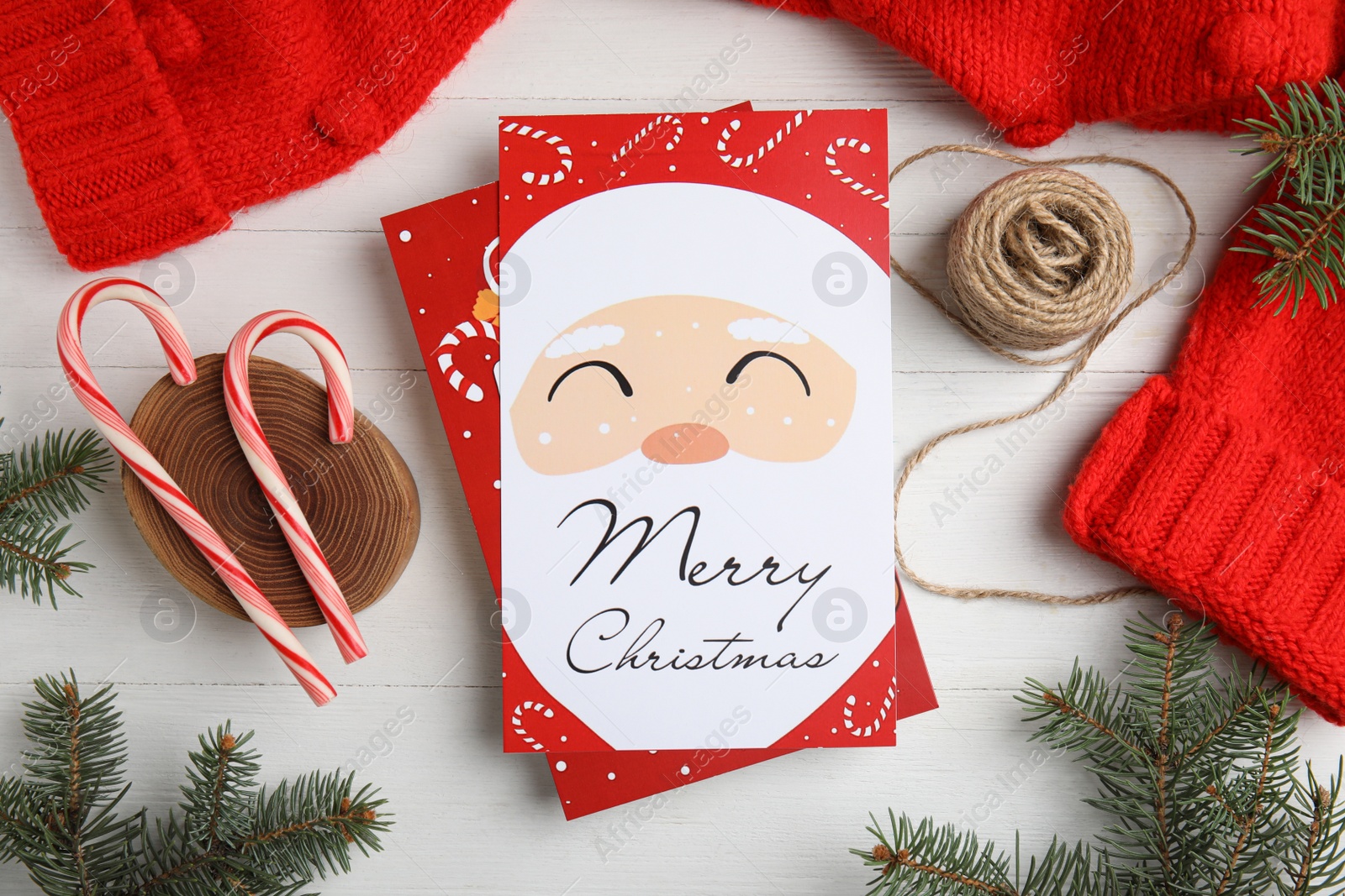 Photo of Flat lay composition with Christmas cards on white wooden background