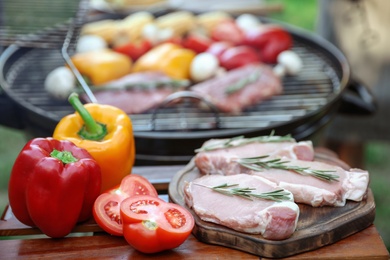 Photo of Modern barbecue grill with fresh products outdoors, closeup