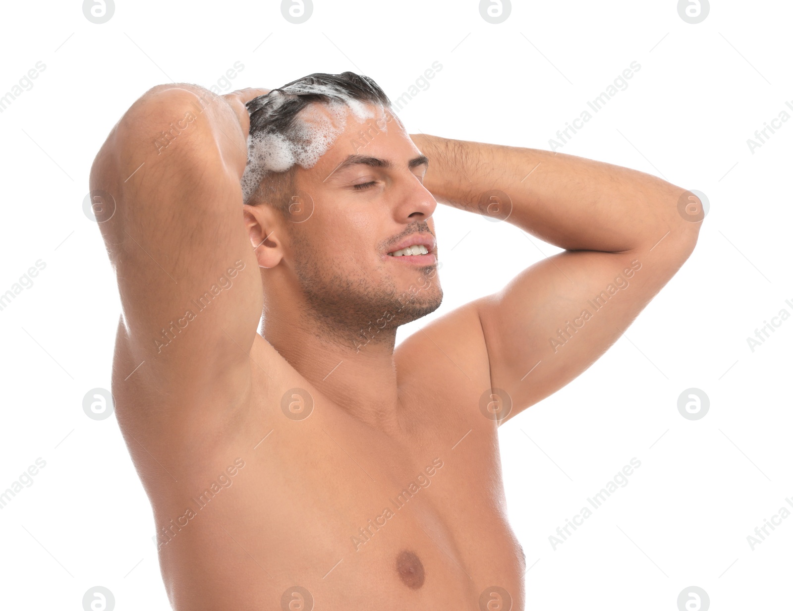 Photo of Handsome man washing hair on white background