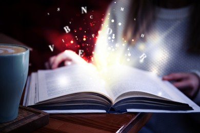 Image of Woman reading shiny magic book with letters flying over it, closeup