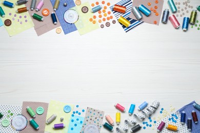 Photo of Different sewing items on white wooden background, flat lay. Space for text