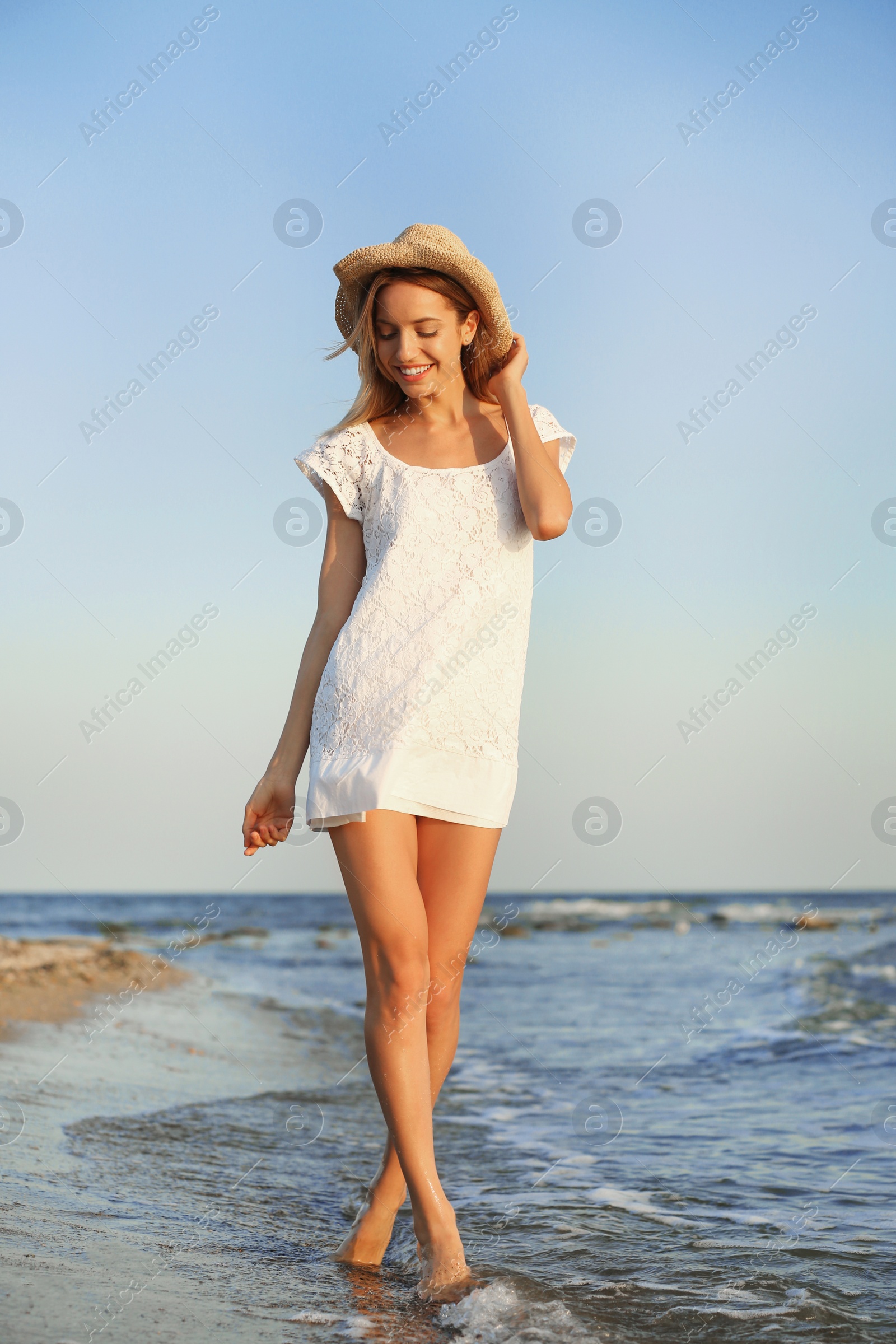 Photo of Young woman enjoying sunny day on beach