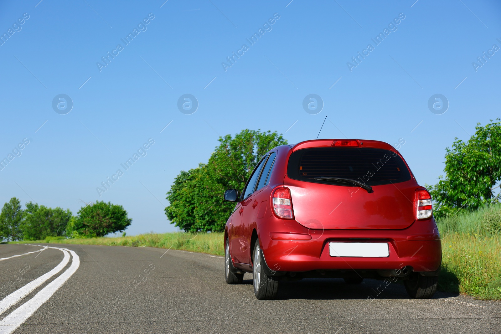 Photo of Modern color family car on highway. Space for text