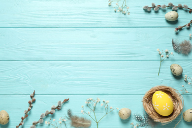 Photo of Flat lay composition with Easter eggs on light blue wooden background. Space for text