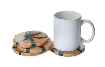 Mug and stylish wooden coasters on white background