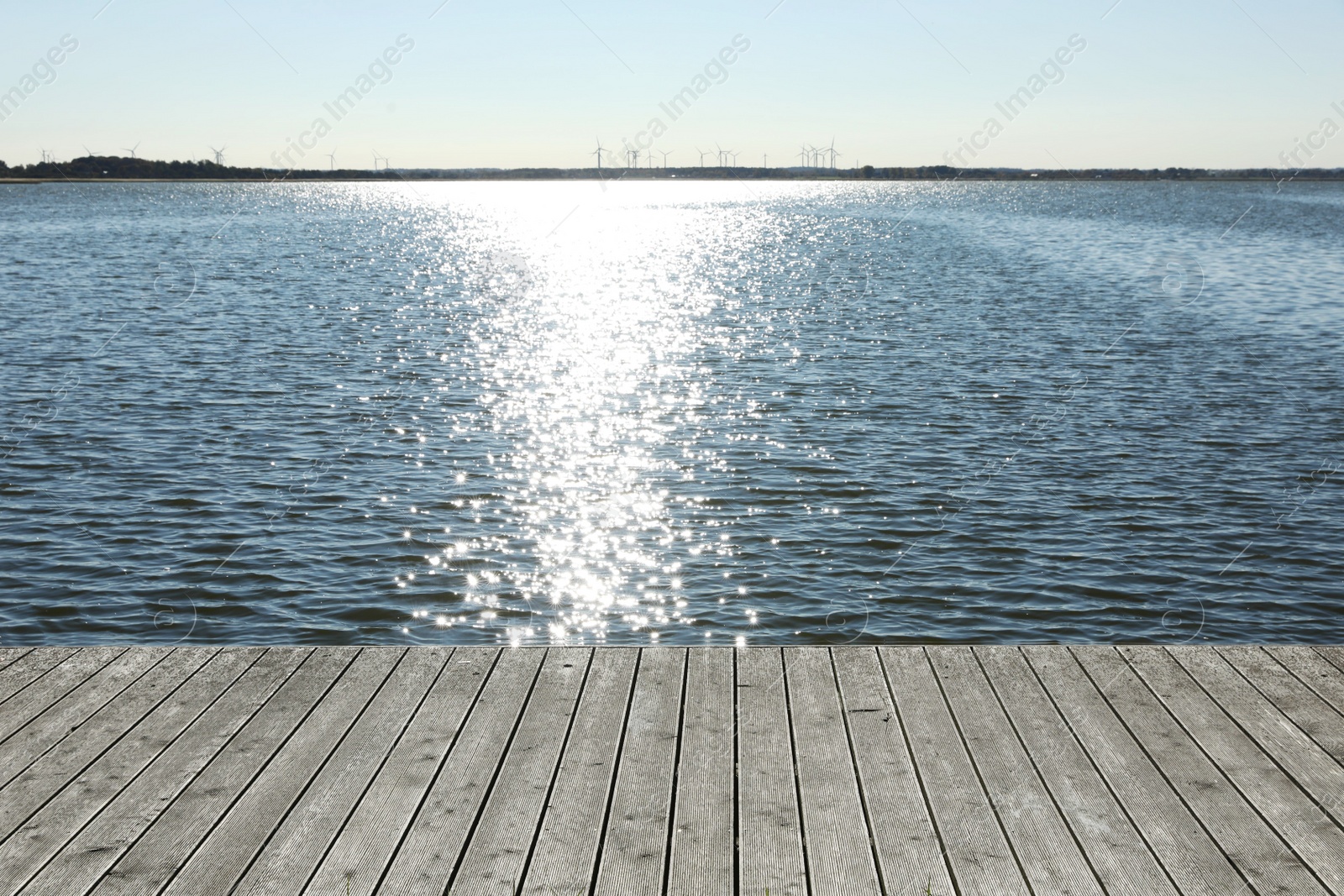 Photo of Beautiful view of wooden terrace near river on sunny day