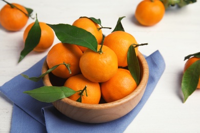 Fresh ripe tangerines in bowl on table