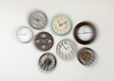 Different clocks on wall, motion blur effect. Time concept